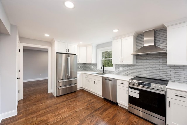 kitchen featuring white cabinets, wall chimney exhaust hood, dark hardwood / wood-style floors, and stainless steel appliances