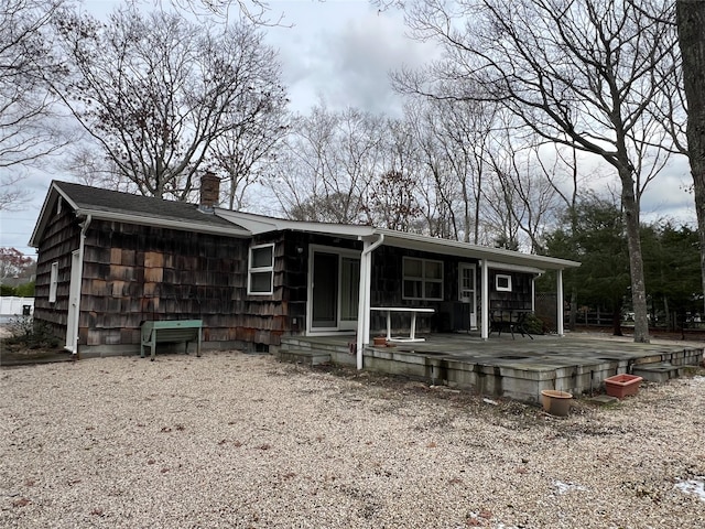 rear view of property featuring a deck