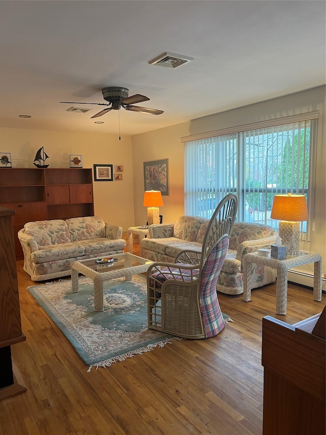 living room featuring hardwood / wood-style flooring and ceiling fan