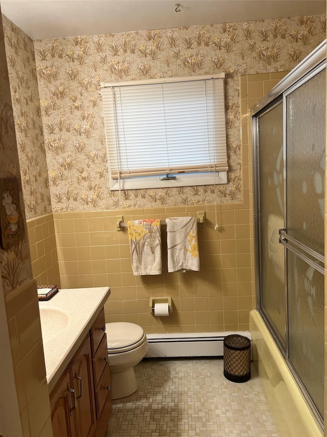 full bathroom featuring vanity, toilet, tile walls, and a baseboard radiator