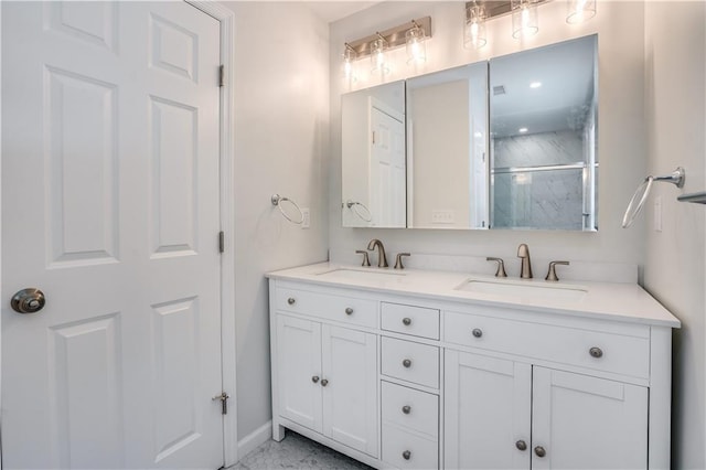 bathroom featuring a shower with door and vanity