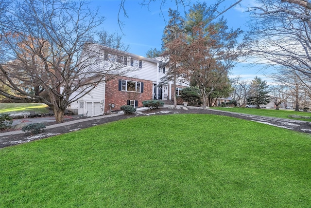 view of front facade with a garage and a front lawn