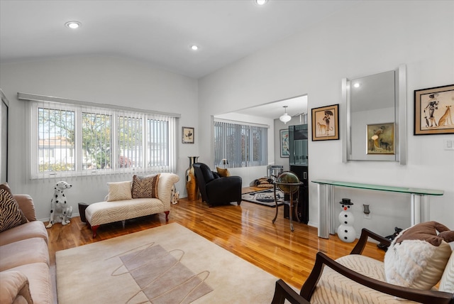 living room featuring hardwood / wood-style floors and vaulted ceiling