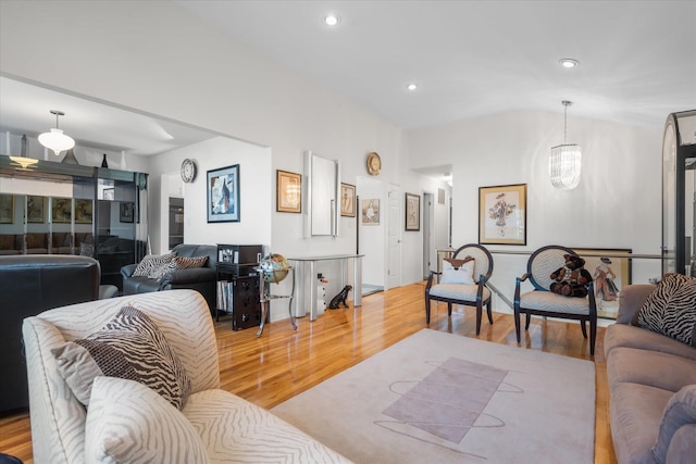 living room with light hardwood / wood-style flooring and a notable chandelier