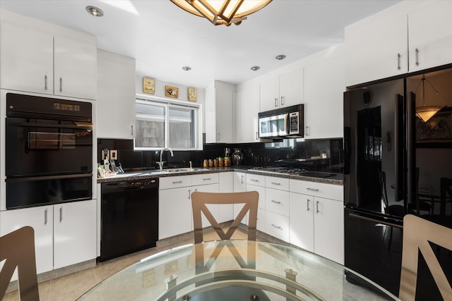 kitchen with black appliances, white cabinets, and sink