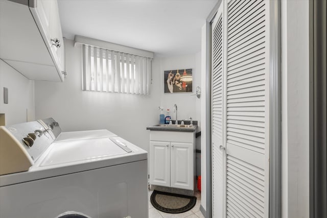 clothes washing area featuring cabinets, independent washer and dryer, light tile patterned flooring, and sink