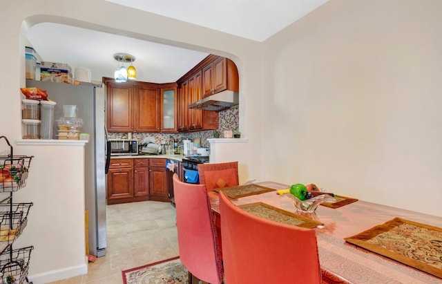 kitchen with tasteful backsplash, light tile patterned floors, and appliances with stainless steel finishes