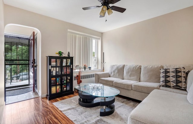 living room featuring radiator, a wealth of natural light, ceiling fan, and hardwood / wood-style flooring