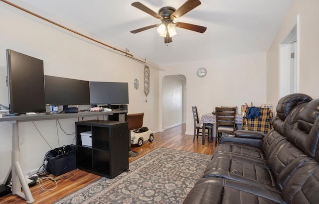 living room featuring ceiling fan and wood-type flooring