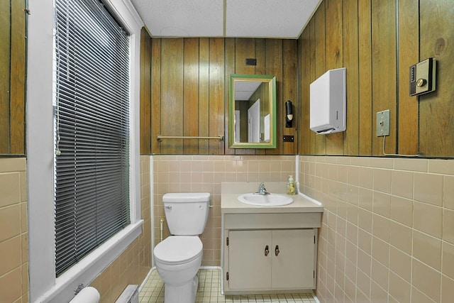 bathroom featuring tile patterned floors, vanity, and toilet