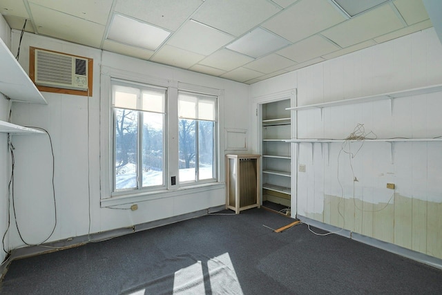 carpeted empty room featuring a wall mounted AC