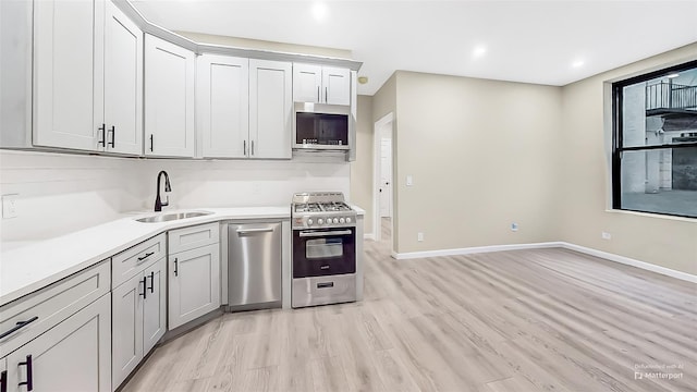 kitchen featuring sink, stainless steel appliances, and light hardwood / wood-style flooring