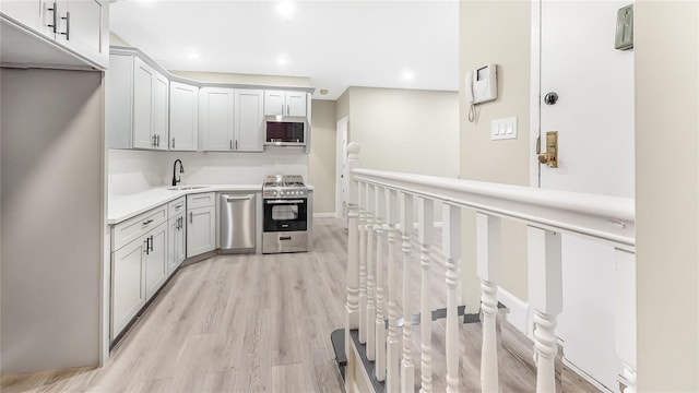 kitchen featuring sink, light wood-type flooring, and appliances with stainless steel finishes