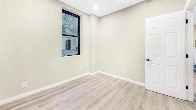 unfurnished room with light wood-type flooring