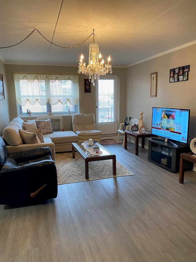 living room with crown molding, an inviting chandelier, and hardwood / wood-style flooring