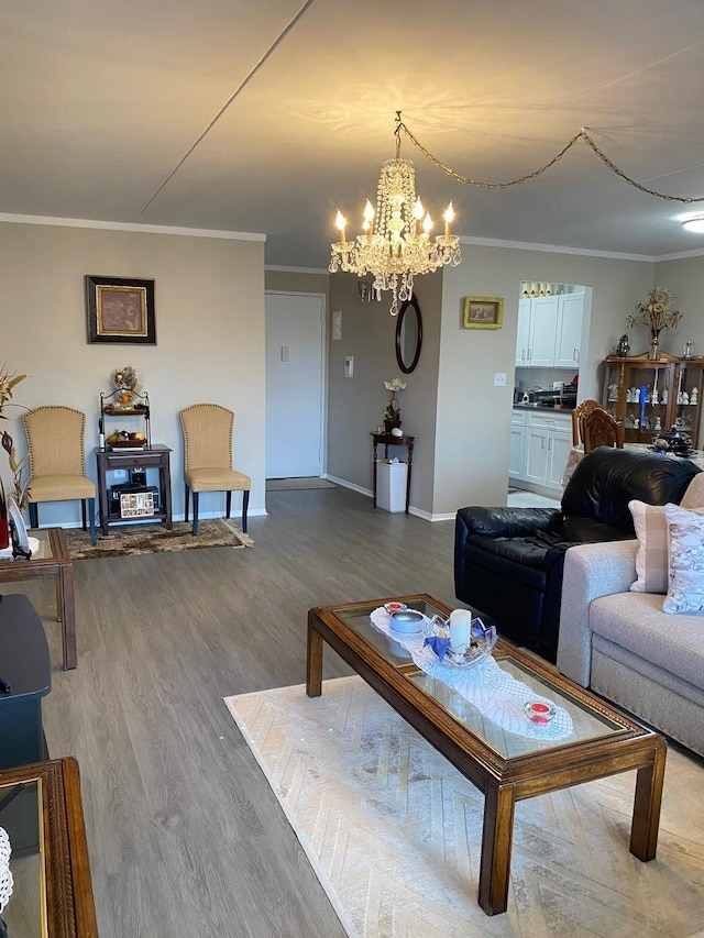 living room featuring a chandelier, hardwood / wood-style floors, and ornamental molding