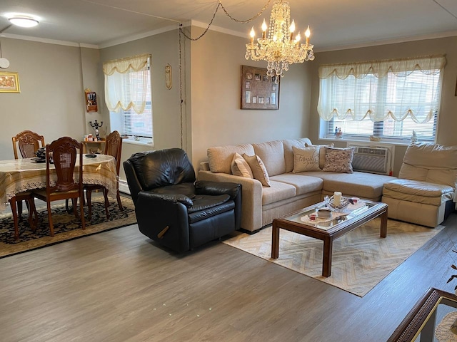 living room featuring light wood-type flooring, ornamental molding, baseboard heating, and a chandelier