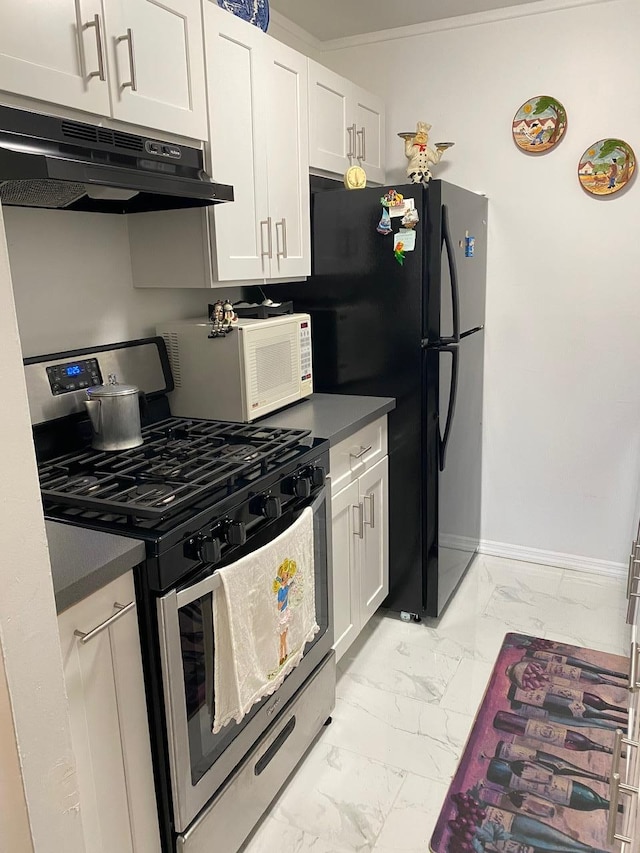 kitchen featuring black fridge, white cabinets, ornamental molding, and stainless steel range with gas stovetop