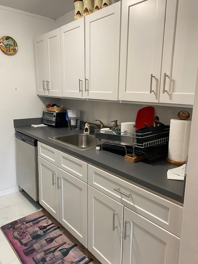 kitchen with white cabinetry, sink, and stainless steel dishwasher