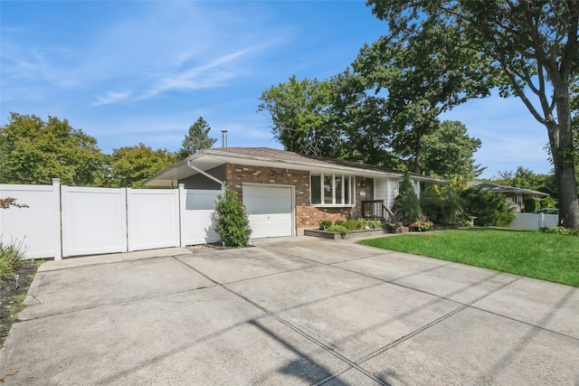 ranch-style house featuring a garage and a front lawn