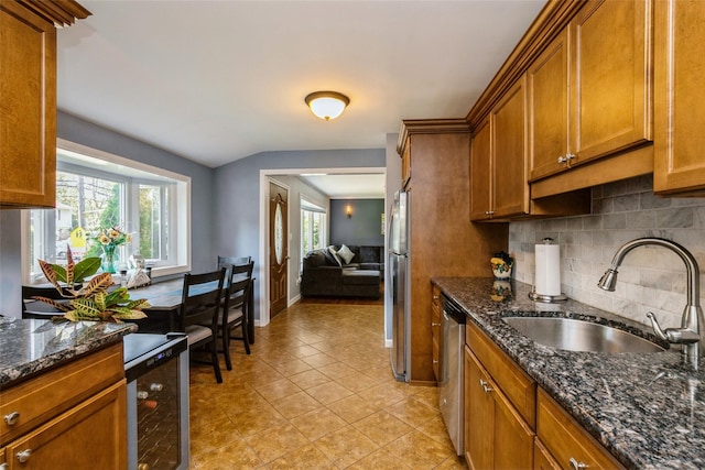 kitchen featuring sink, appliances with stainless steel finishes, plenty of natural light, and wine cooler