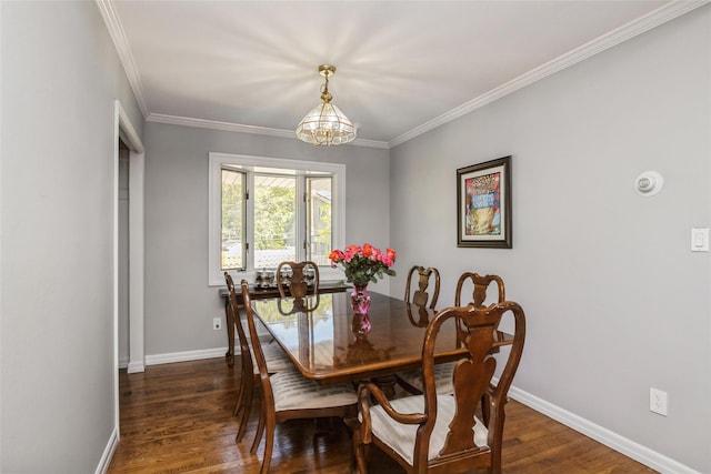 dining area with dark hardwood / wood-style floors, a notable chandelier, and ornamental molding