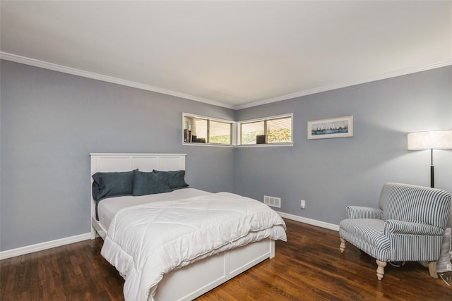 bedroom with dark hardwood / wood-style floors and crown molding