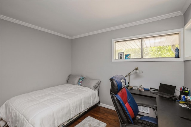 bedroom with ornamental molding and dark hardwood / wood-style floors