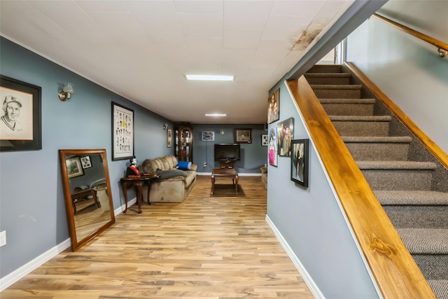 stairs featuring hardwood / wood-style floors