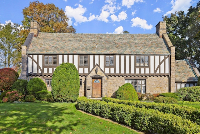 tudor house with a front lawn