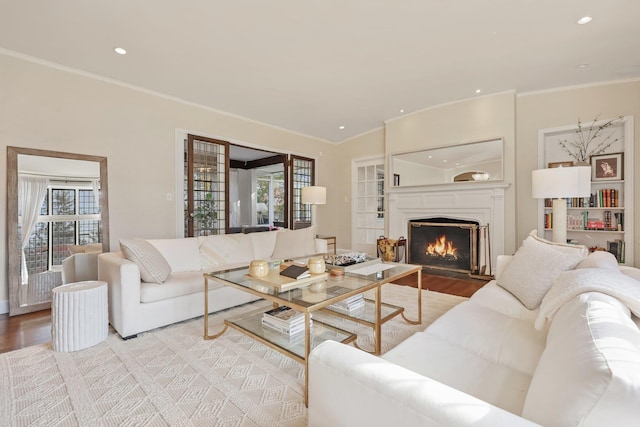 living room with crown molding and light hardwood / wood-style flooring