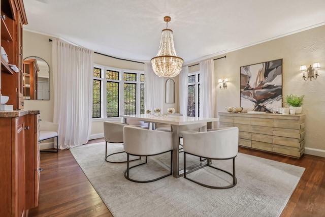 dining room with dark wood-type flooring, crown molding, and a chandelier