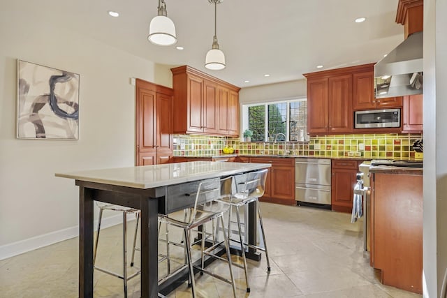 kitchen featuring sink, tasteful backsplash, a center island, hanging light fixtures, and appliances with stainless steel finishes