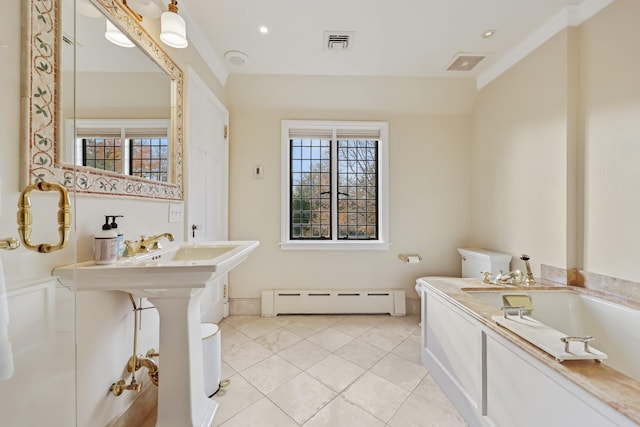 bathroom with tile patterned flooring, a baseboard heating unit, and a tub to relax in