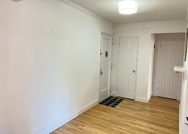 interior space with crown molding and light hardwood / wood-style floors