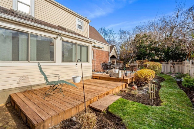 wooden terrace featuring a yard