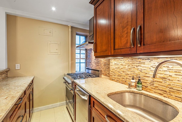 kitchen with sink, appliances with stainless steel finishes, tasteful backsplash, light tile patterned flooring, and light stone counters