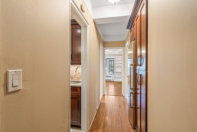 corridor featuring light hardwood / wood-style floors and sink