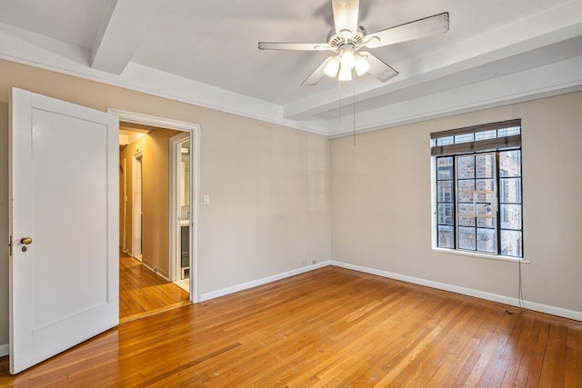 empty room with beam ceiling, ceiling fan, and hardwood / wood-style flooring