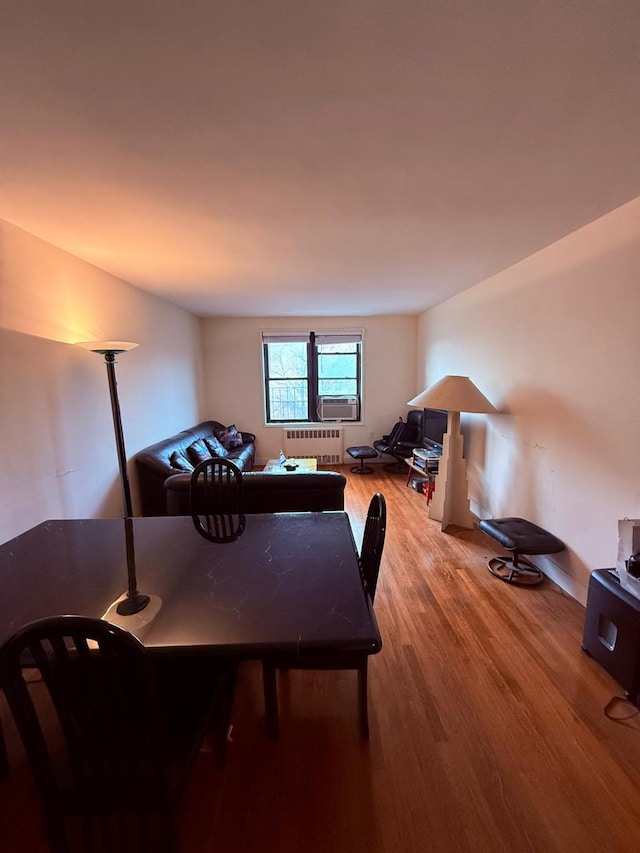 dining space featuring radiator heating unit and light hardwood / wood-style floors