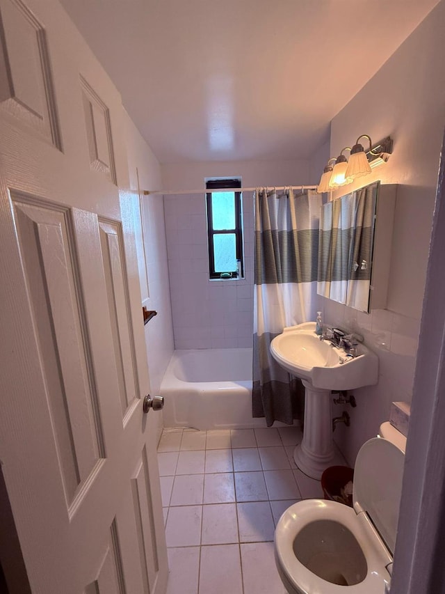 full bathroom featuring sink, tile patterned flooring, shower / bathtub combination with curtain, and toilet