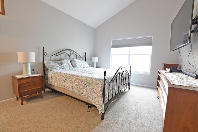 carpeted bedroom featuring high vaulted ceiling