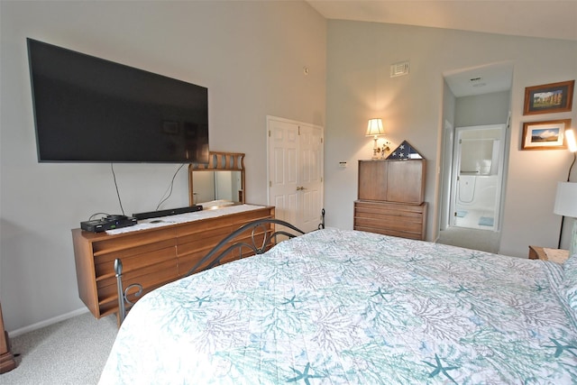 bedroom featuring carpet, vaulted ceiling, and ensuite bath