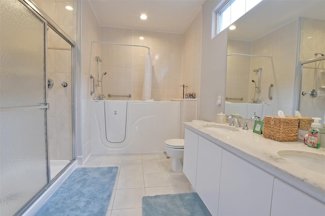 bathroom with tile patterned flooring, vanity, toilet, and a shower with shower door