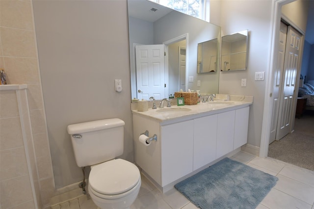 bathroom featuring tile patterned flooring, vanity, and toilet