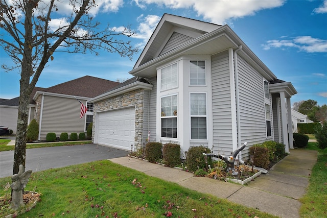 view of side of property with a yard and a garage