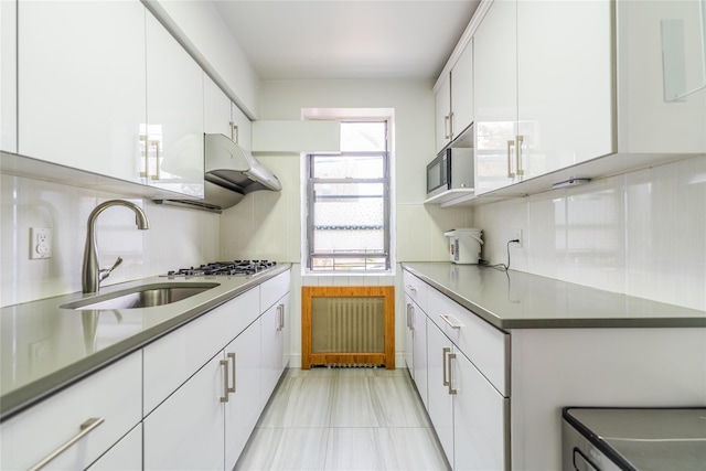 kitchen featuring white cabinetry, sink, light tile patterned flooring, and appliances with stainless steel finishes