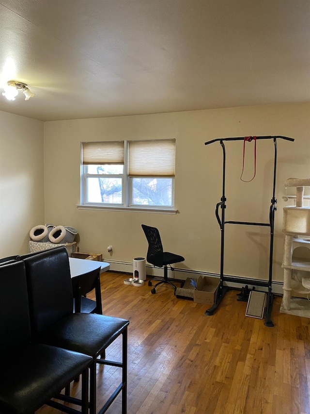 workout area with light hardwood / wood-style floors