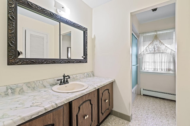 bathroom with tile patterned flooring, vanity, and a baseboard radiator