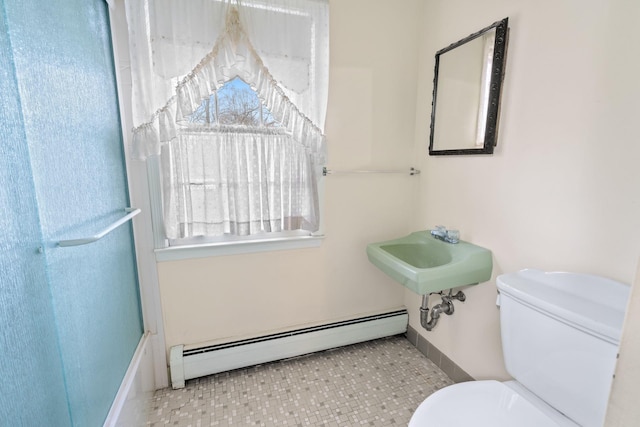 bathroom with baseboard heating, sink, and toilet